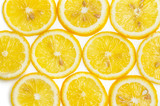 Background of fresh yellow lemon slices on white