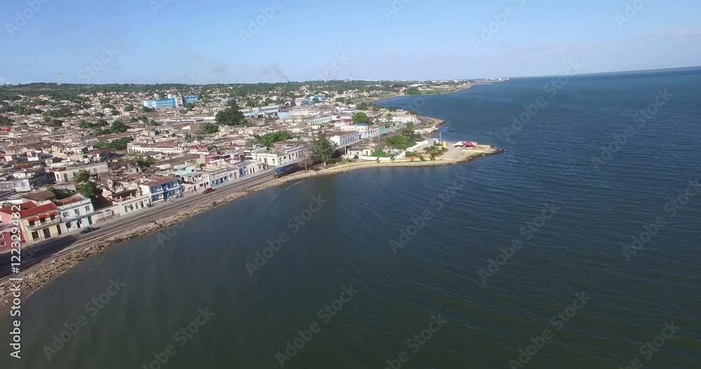 Bird's-eye view from drone to landscape of peninsula, main road, local houses, railway and small park on a shore Caribbean Sea at summer sunny day Bird's-eye view from drone to landscape of peninsula, main road, local houses, railway and small park on a shore Caribbean Sea at summer sunny day