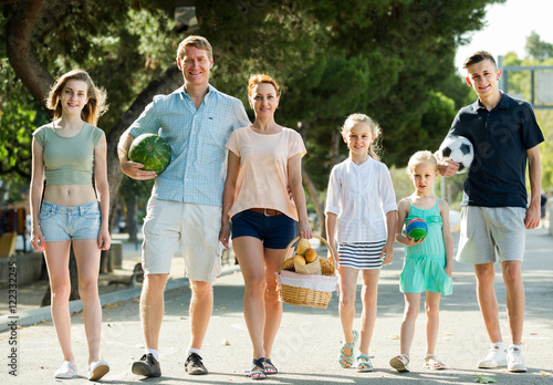 ﻿family walking in summer city