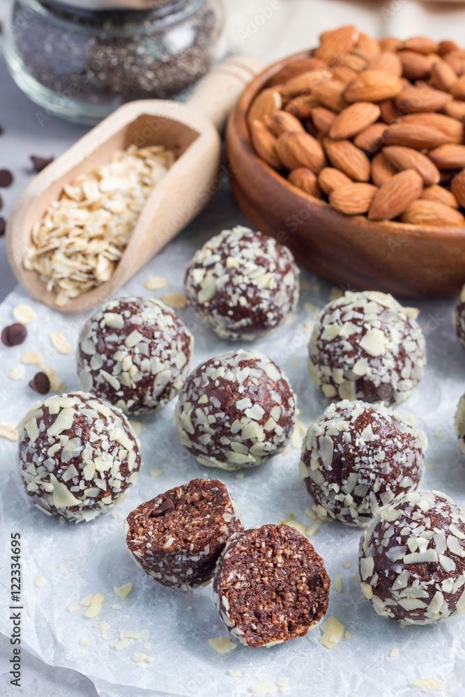 Healthy homemade paleo chocolate energy balls on parchment, vertical Healthy homemade paleo chocolate energy balls on parchment, vertical