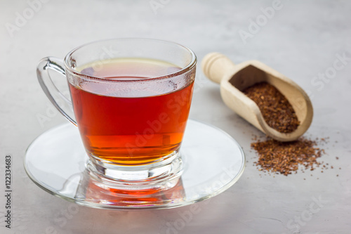 Cup of healthy herbal rooibos red tea in glass cup