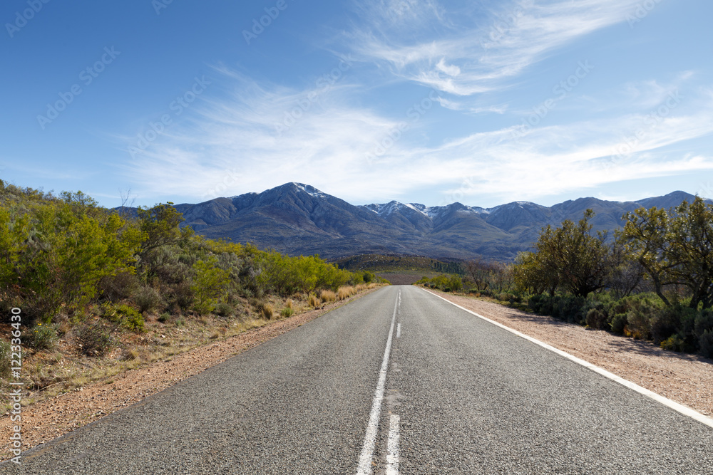 The road to the The Swartberg Pass with clouds and snow
