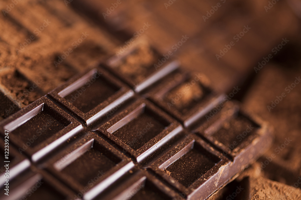 Dark homemade chocolate bars and cocoa pod on wooden Dark homemade chocolate bars and cocoa pod on wooden