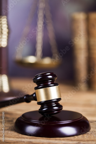 Mallet of the judge, justice scale, wooden desk background