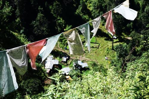 Prayer flags hanging from a rope on a Himalayan mountain in Bhut