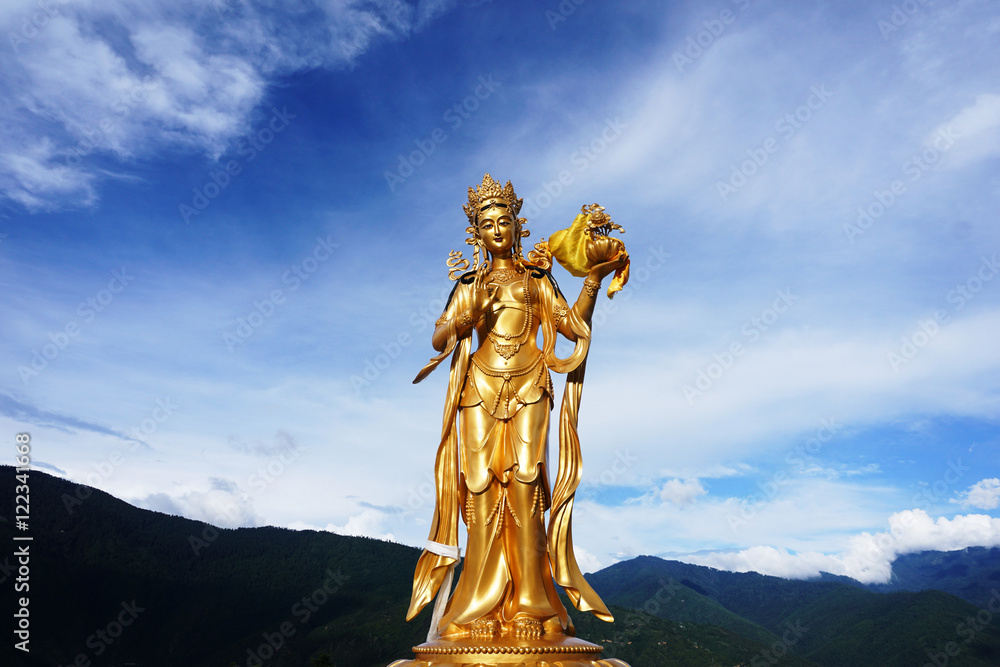A golden female angel statue in a buddhist temple