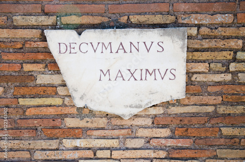 Ruins of ancient Ostia. White marble plaque indicating the Decumanus Maximus