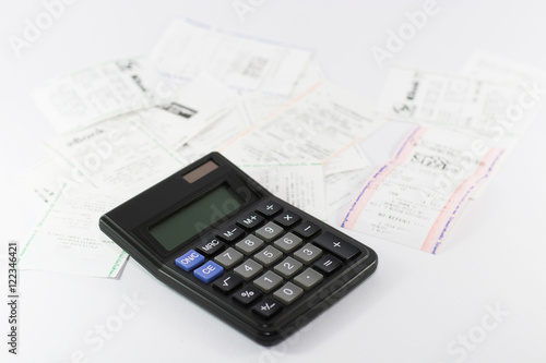 A calculator with receipt, household bills