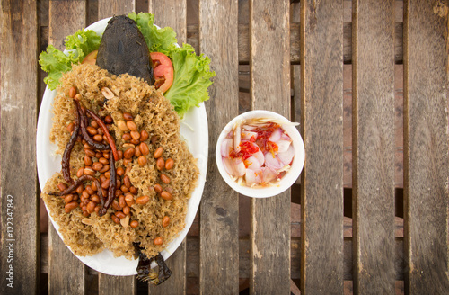  Fried Crispy Catfish served with Spicy Mango Salad on whe wood table photo