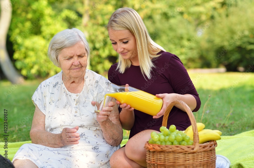 Elderly woman and young woman at the picnic.