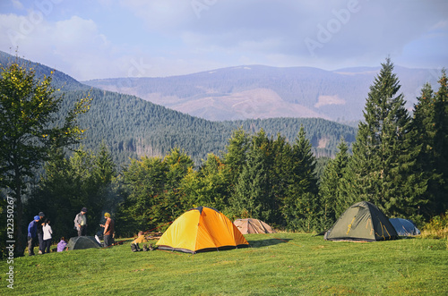 Mountain landscape at sunshine. Tourist tents in forest   Carpathian 