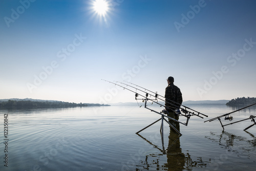 Fishing adventures. Fisherman near the carpfishing equipment 