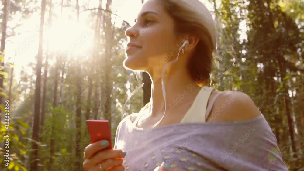 Portrait of pretty smiling young woman jogging in nature and enjoying fresh air Portrait of pretty smiling young woman jogging in nature and enjoying fresh air