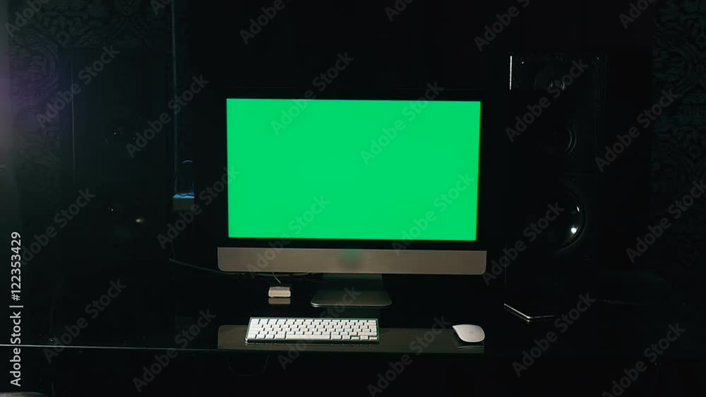 Chroma key. Stylish workspace with computer green screen and audio dinamics on home or studio