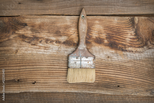 Brush with wooden handle on the vintage, wooden, brown background photo