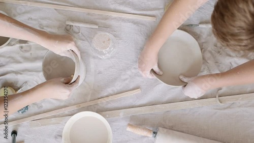 Girl sculpts clay dishes. Top view. Timelapse 