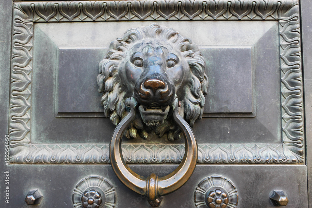Ancient door knocker in the shape of a lion's head