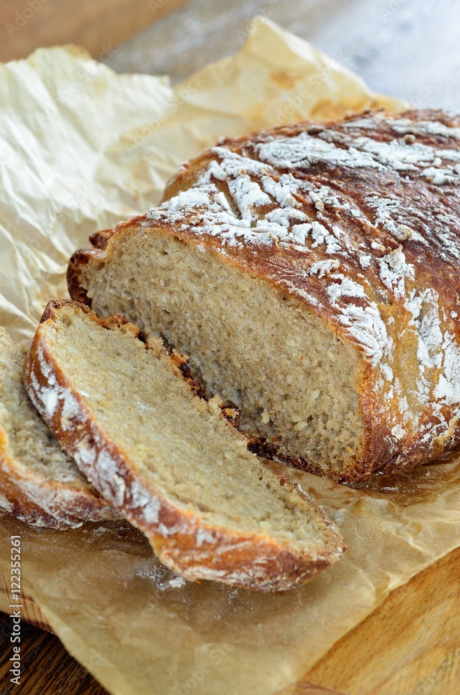 Sliced bread with sesame seeds on parchment paper Sliced bread with sesame seeds on parchment paper