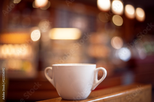 cup of coffee  on wooden table. picture wiyh soft focus