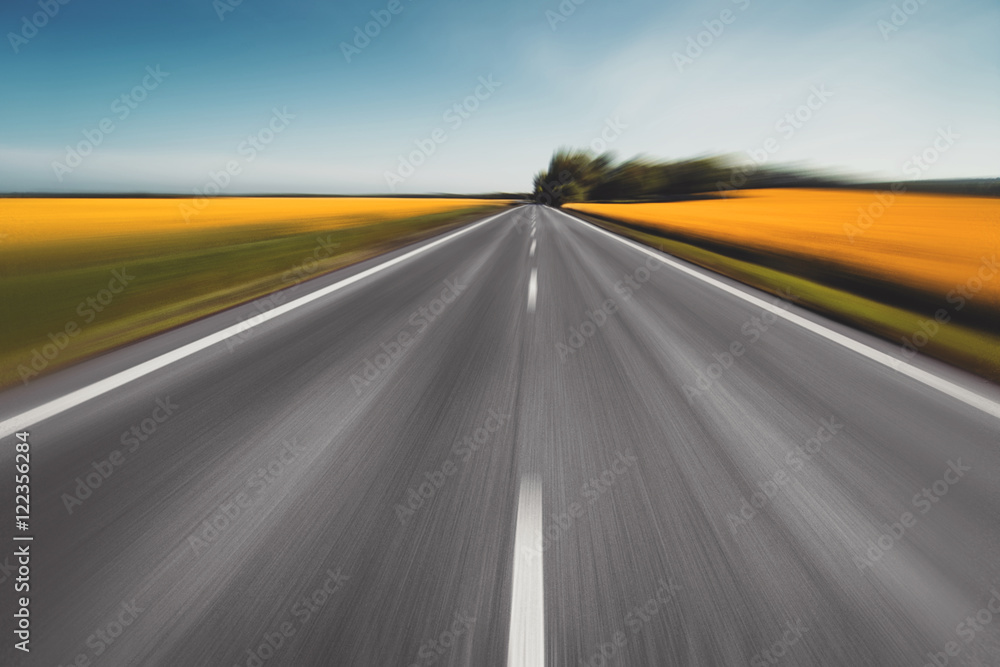 empty asphalt road and floral field of yellow flowers. natural empty asphalt road and floral field of yellow flowers. natural