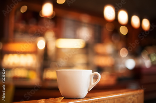 cup of coffee in cafe interior. picture with soft focus and blur