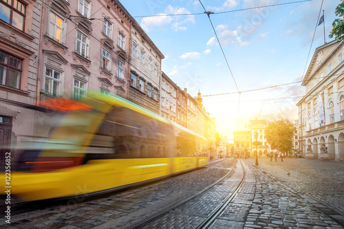 yellow tram rides on the morning  old european city. photo