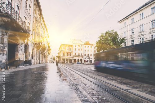 Blue tram rides on the morning  old european city. vintage picture