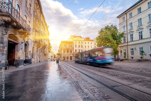 Blue tram rides on the morning  old european city.vintage picture photo