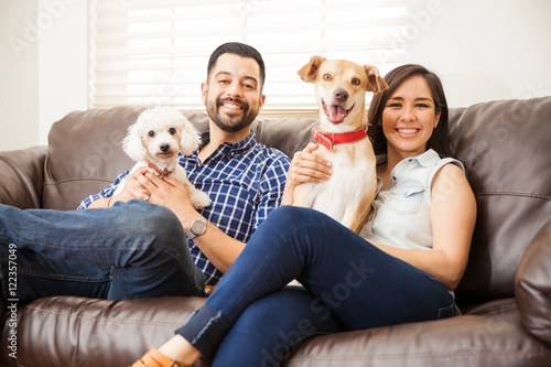Photography Happy family of a young couple with two dogs at home
