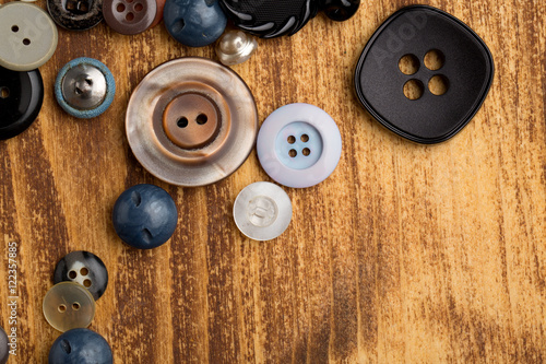 Set of vintage buttons on old wooden table