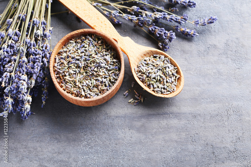 Fototapeta Naklejka Na Ścianę i Meble -  Lavender flowers in bowl and spoon on grey table