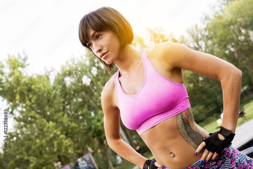 Fototapeta premium Young girl doing workout outside.
