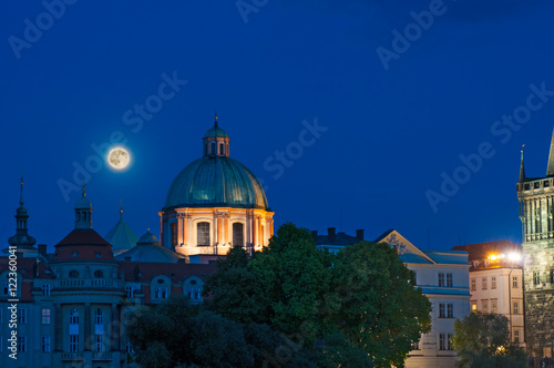 Full moon over Prague cathedral at night
