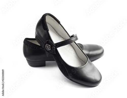 Pair of black shoes for girl on white background