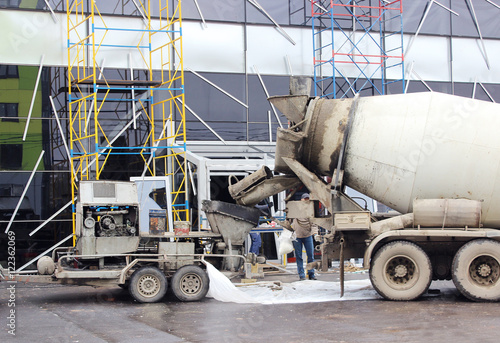 concrete pump and  mixer to work together  pouring cement floors in the shopping center for repair.