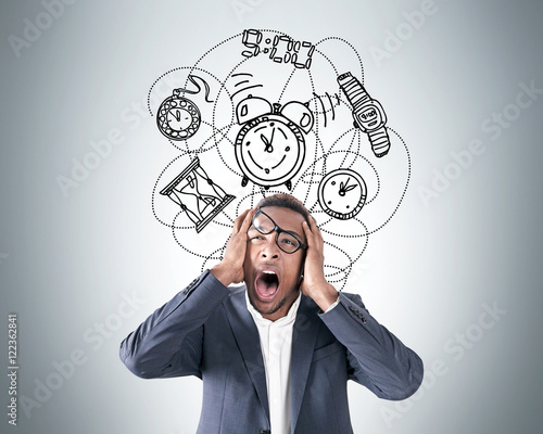 Fotografija African American man overwhelmed with time deficit