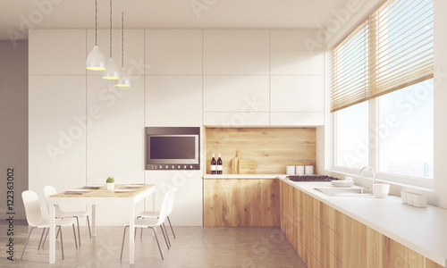 Front view of sunlit kitchen table and TV set