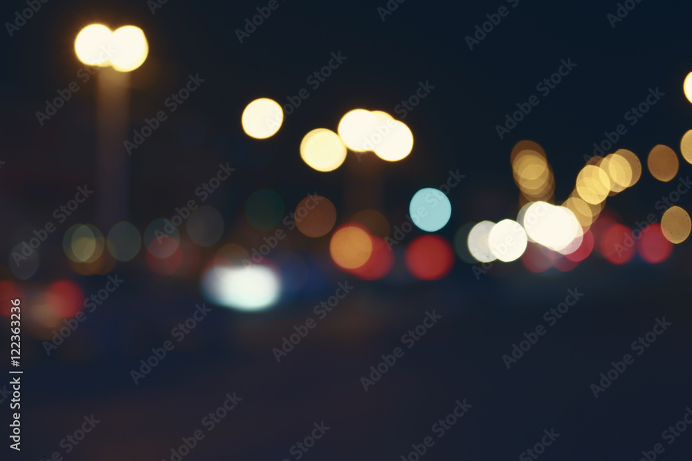 Retro toned blurred street and car lights, urban abstract night time background.
