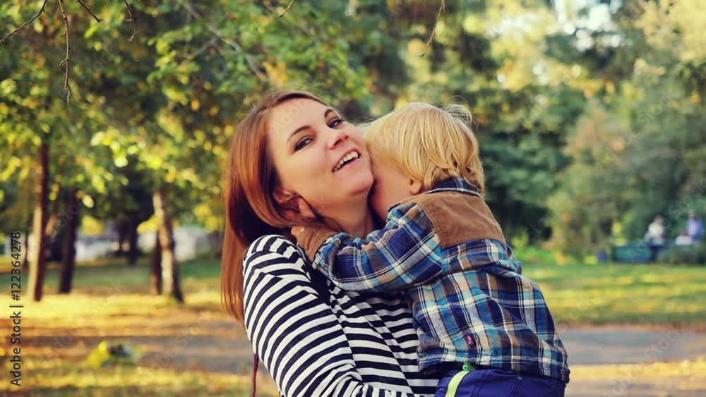 Mother and her child enjoy the early autumn in slowmotion. Mom hugs her son. 1920x1080 Mother and her child enjoy the early autumn in slowmotion. Mom hugs her son. 1920x1080