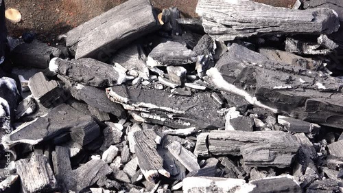 Scatter ashes and fire mixed with smoke in the wind from the hot coals