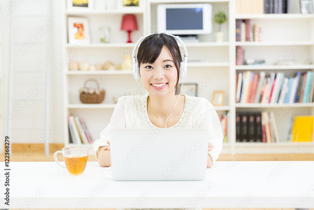 attractive asian woman using laptop computer
in the living room attractive asian woman using laptop computer
in the living room