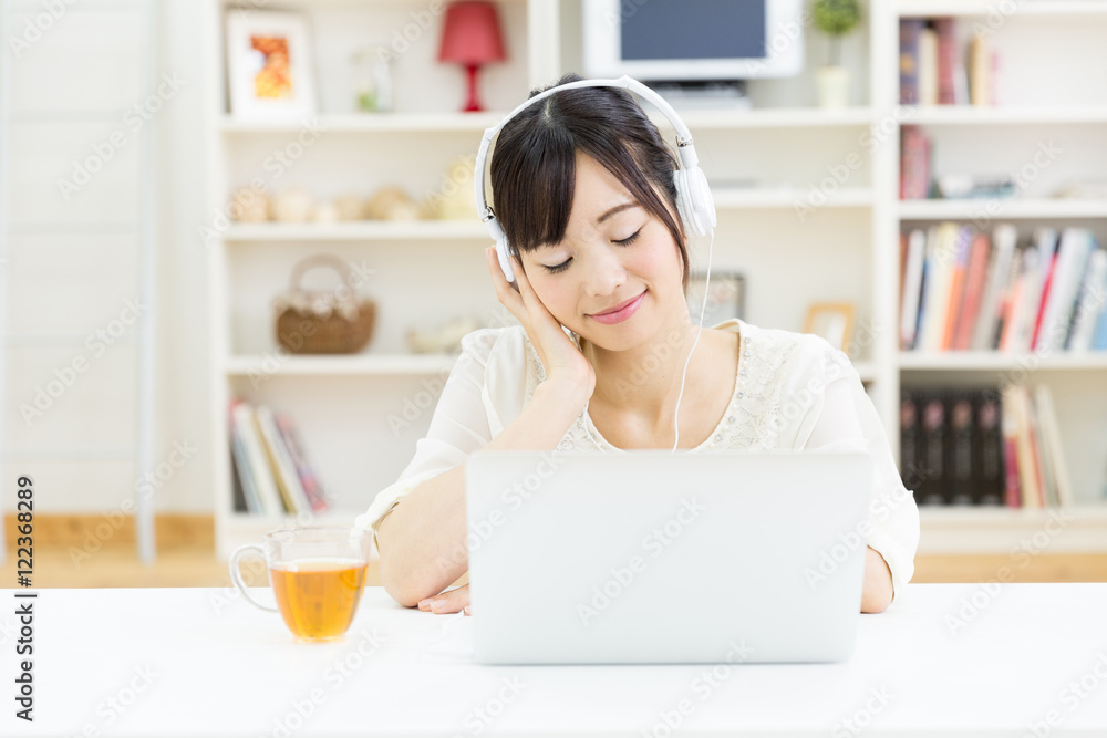 attractive asian woman using laptop computer
in the living room attractive asian woman using laptop computer
in the living room
