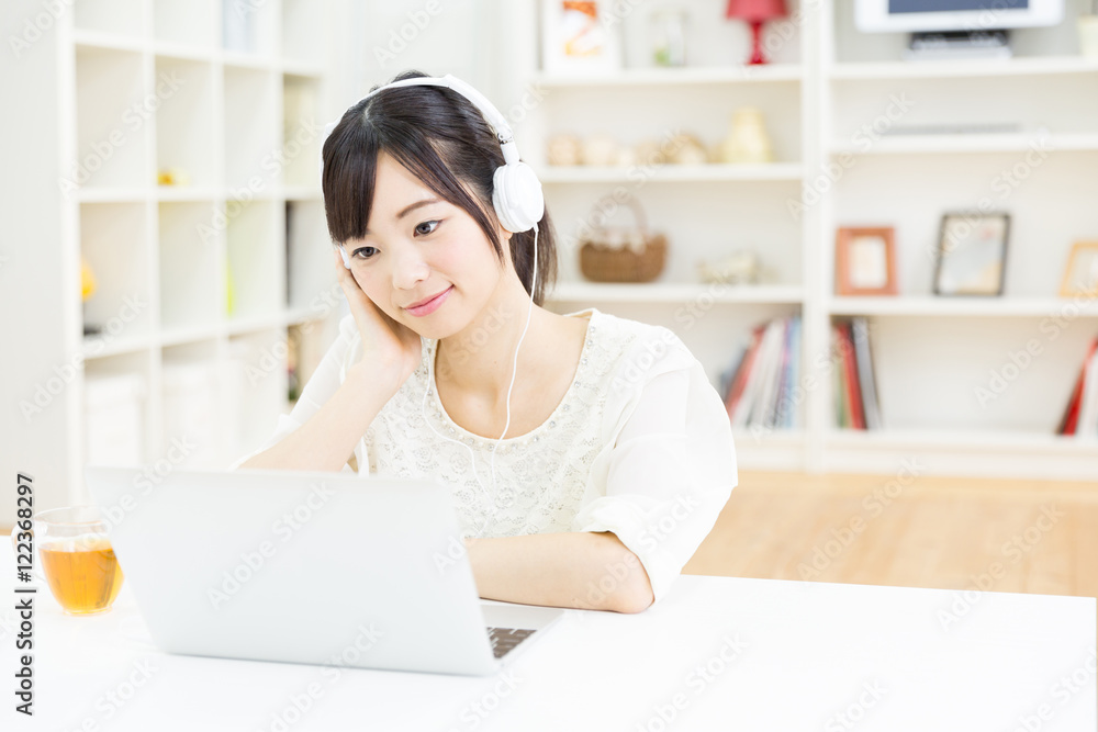 attractive asian woman using laptop computer
in the living room attractive asian woman using laptop computer
in the living room