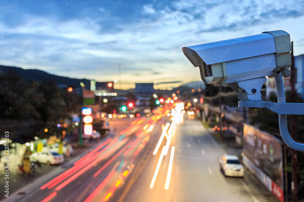 Security CCTV camera operating over the road Photos | Adobe Stock