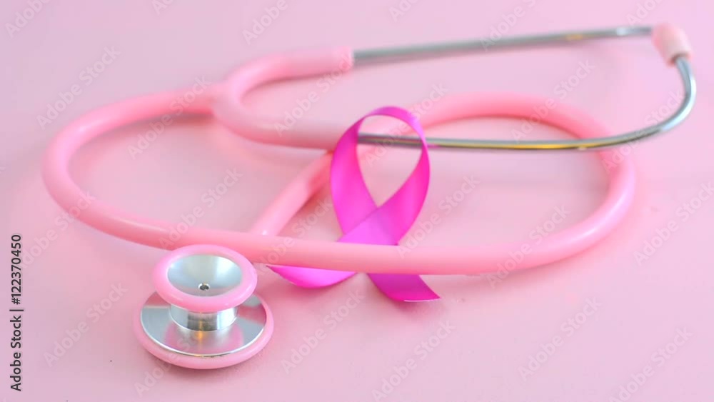 Breast Cancer Awareness with pink stethoscope and pink ribbon symbol, placing ribbon. Breast Cancer Awareness with pink stethoscope and pink ribbon symbol, placing ribbon.