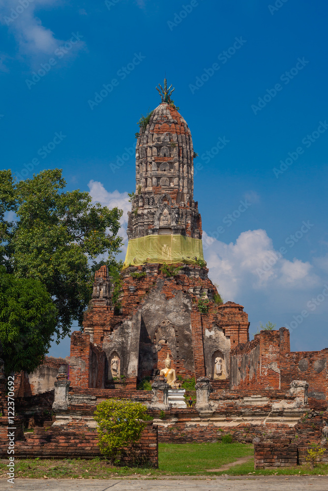 Buddha statue and a ruined building of Wat Choeng Tha Temple, province Ayutthaya, inThailand