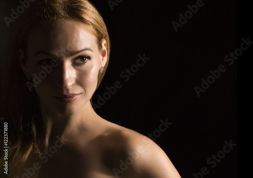 portrait of beautiful sensuality pensive woman profile wit in a dark