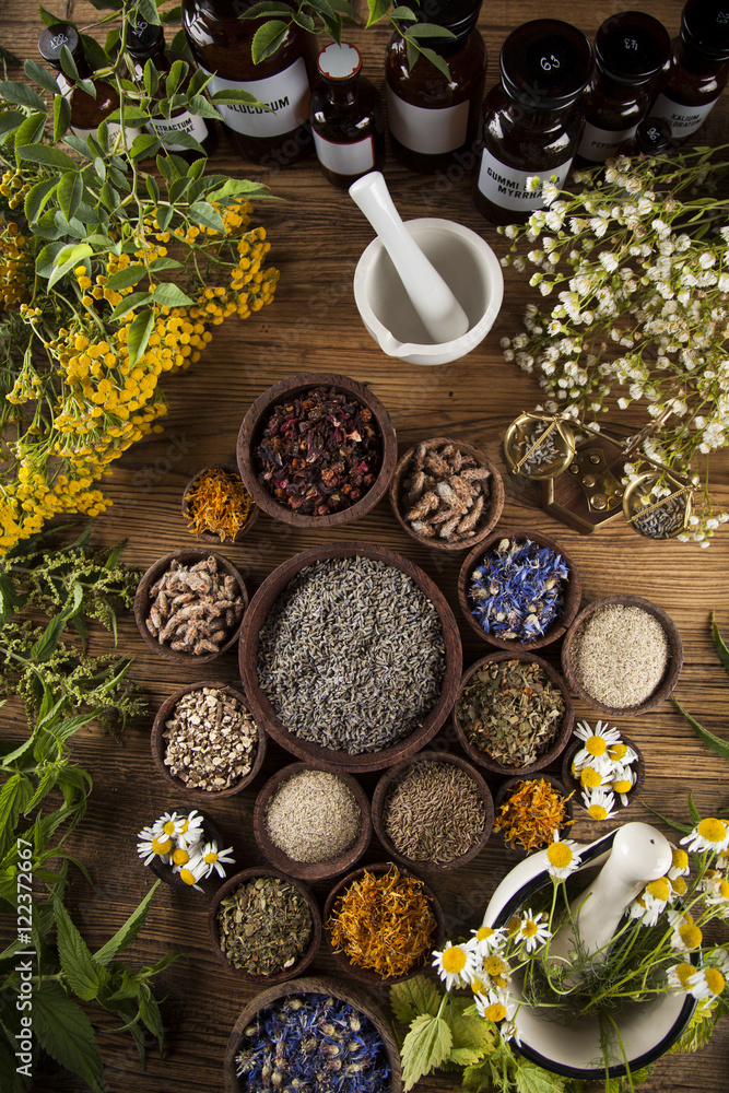 Natural medicine, herbs, mortar on wooden table background Natural medicine, herbs, mortar on wooden table background