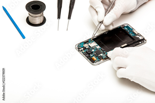 technician repairing broken mobile phone