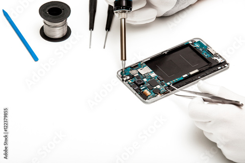 technician repairing broken mobile phone